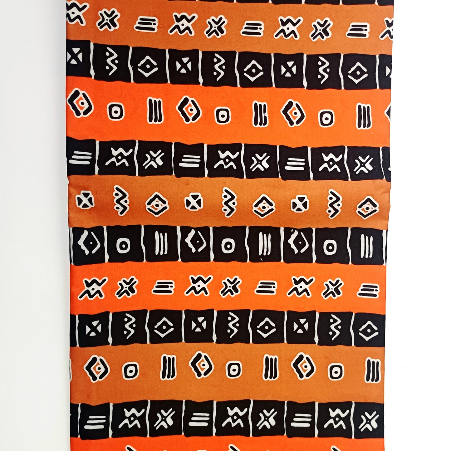 Textile with black geometric patterns on an orange background