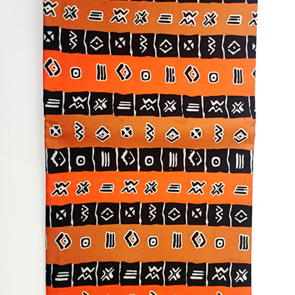 Textile with black geometric patterns on an orange background