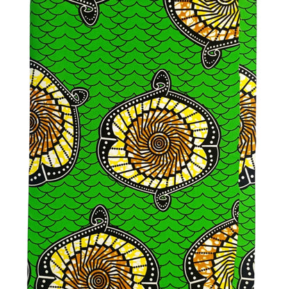 Traditional patterned fabric with yellow and black designs on a green background
