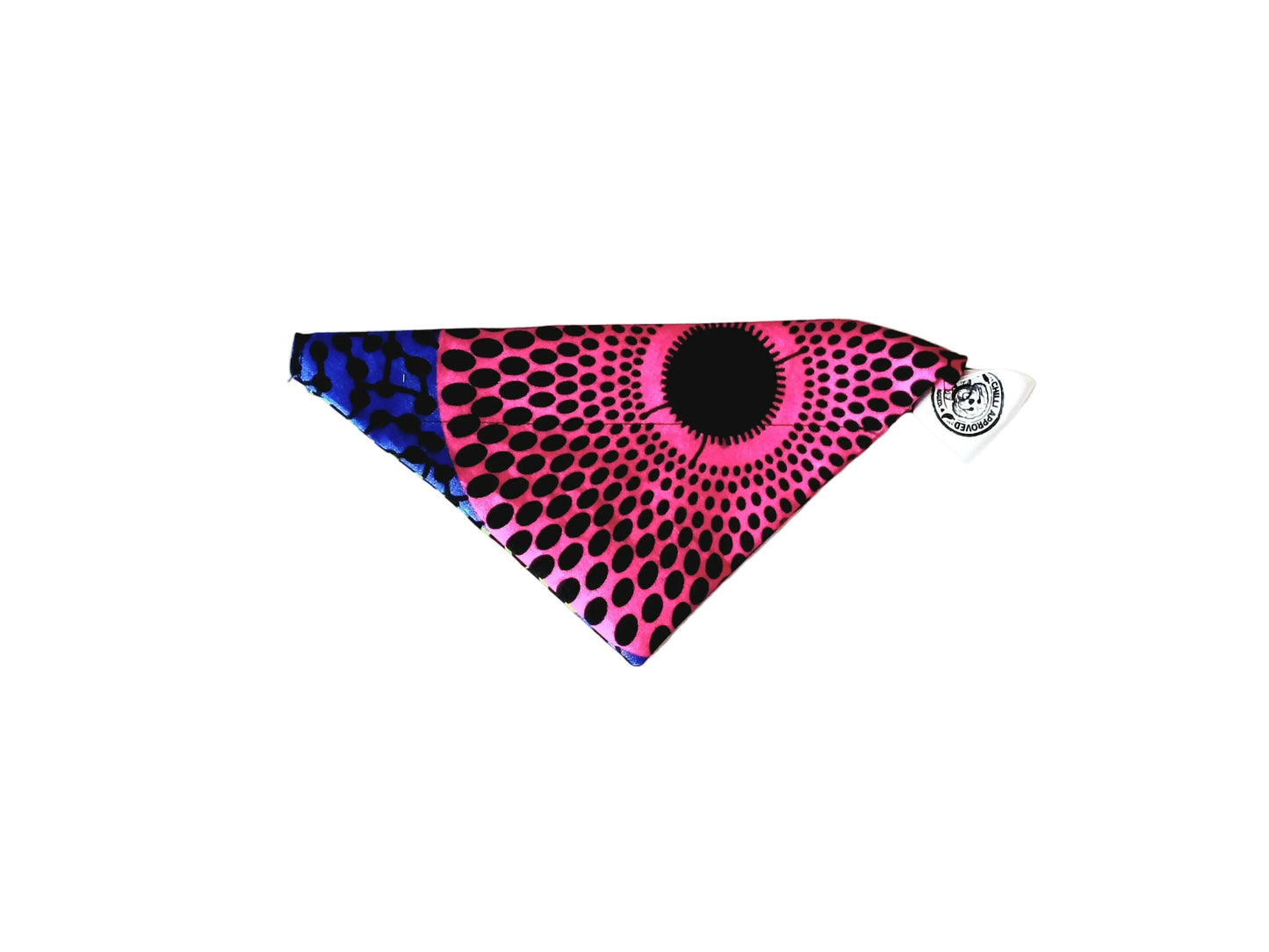 A triangular pet bandana featuring a vibrant pink and black concentric dot pattern with a blue and black print section, displayed on a plain white background.