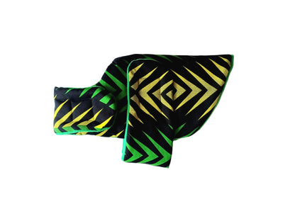 A dog coat with a bold black, green, and yellow geometric pattern, displayed on a plain white background.