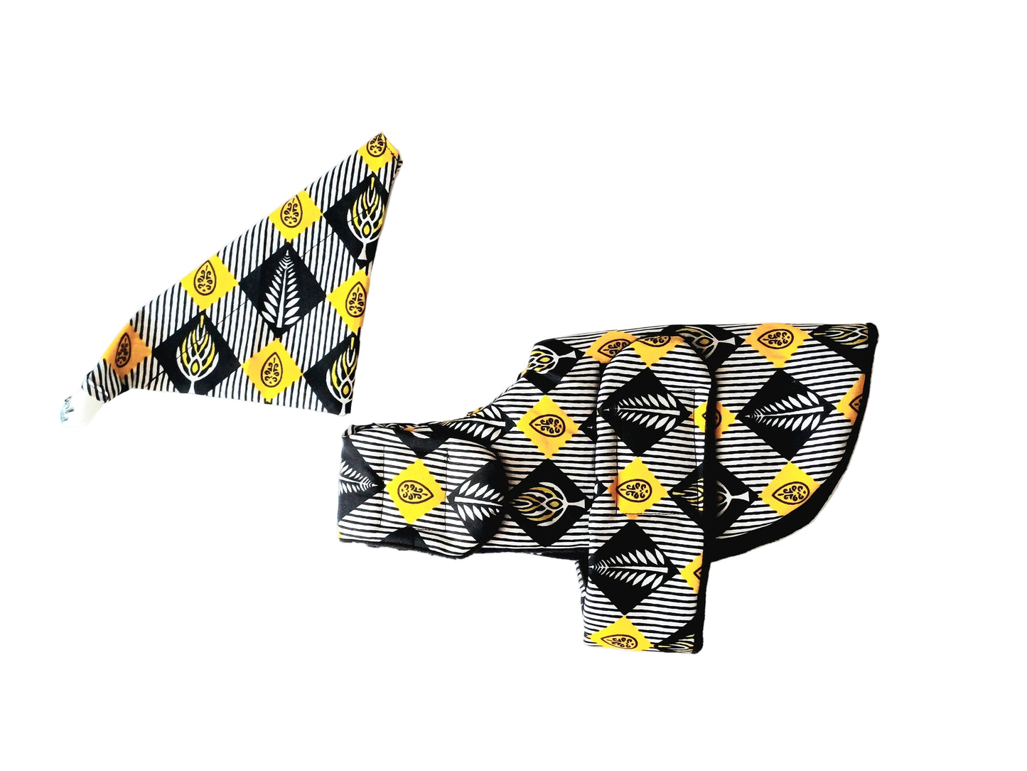 A  black, white, and yellow patterned fabric dog coat and Bandana set laid flat on a white background.