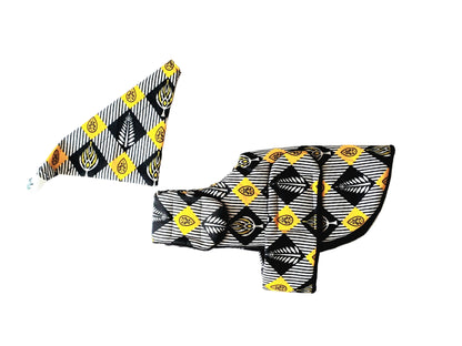 A  black, white, and yellow patterned fabric dog coat and Bandana set laid flat on a white background.