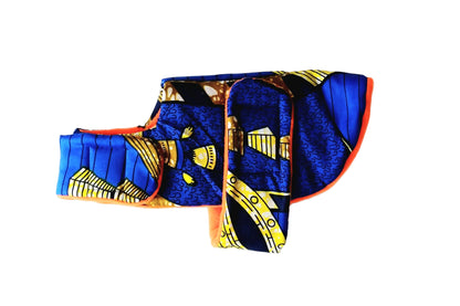A dog coat with a bold blue, yellow, and black pattern, photographed flat against a plain white background.