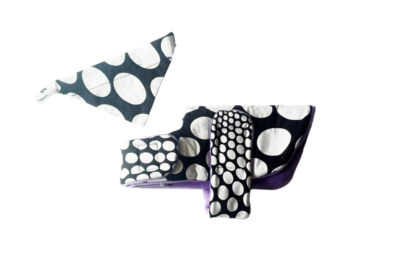 Black and white polka dot dog coat set on a white background