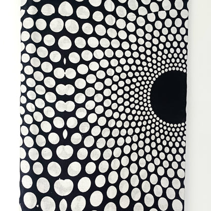 Black and white patterned fabric with a central black circle