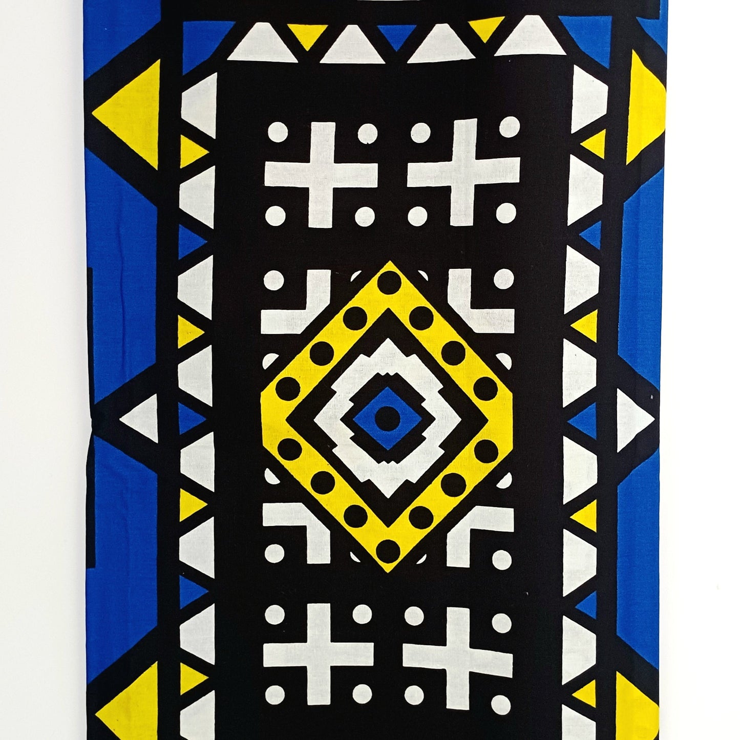 Fabric with geometric pattern featuring blue, yellow, and black colours.