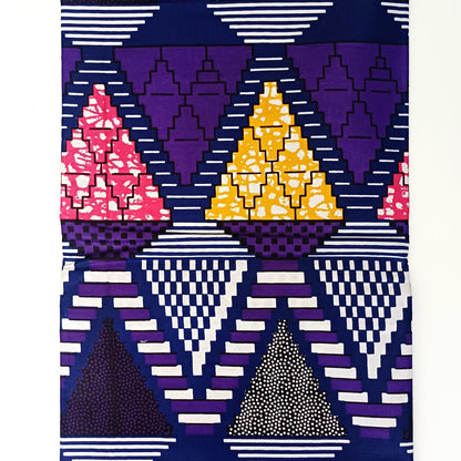 Geometric patterned fabric with triangles in purple, yellow, and pink on a white background